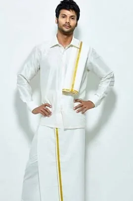 Man wearing a traditional white South Indian dhoti and shirt with a gold border