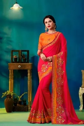 Woman modelling a pink and orange embroidered silk saree, traditional Indian attire
