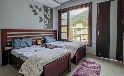 Twin room with two single beds and a window onto the hills