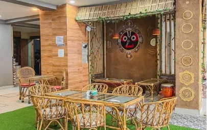 A cane dining set before a Jagannath shrine corner