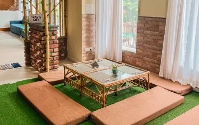 Low tables with floor cushions near the Shanti Cafe sign