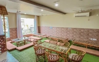 The bright cafe hall with cane seating and floor tables