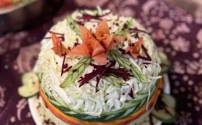 A salad decorated with a carved carrot flower