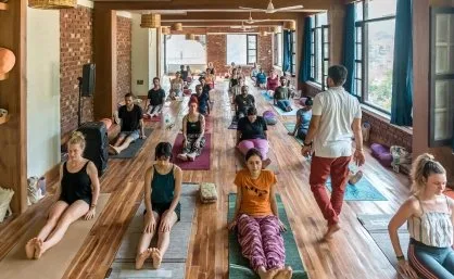 A teacher walking among students during a seated class