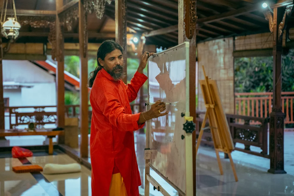 Guru Vishnu teaching at a whiteboard in the Bali shala