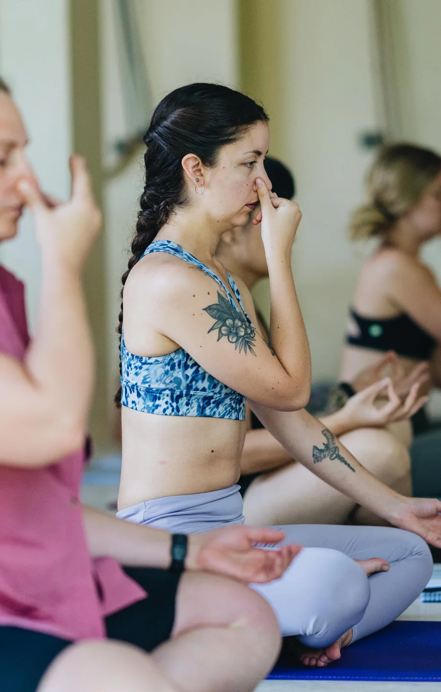 Students practising alternate nostril breathing in meditation