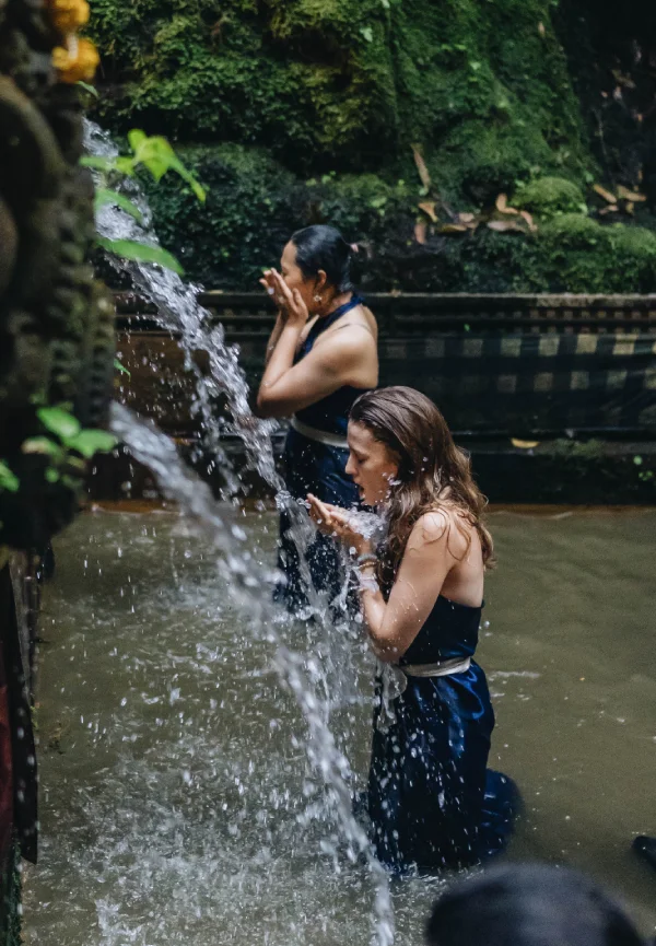 Students purifying under the holy spring spouts at Tirta Empul