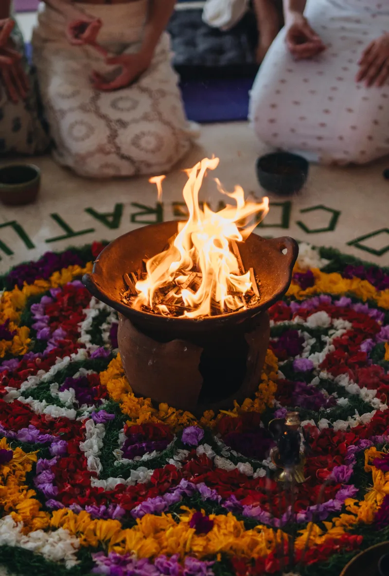 A sacred fire burning at the centre of a flower mandala during a Trika Tantra ritual
