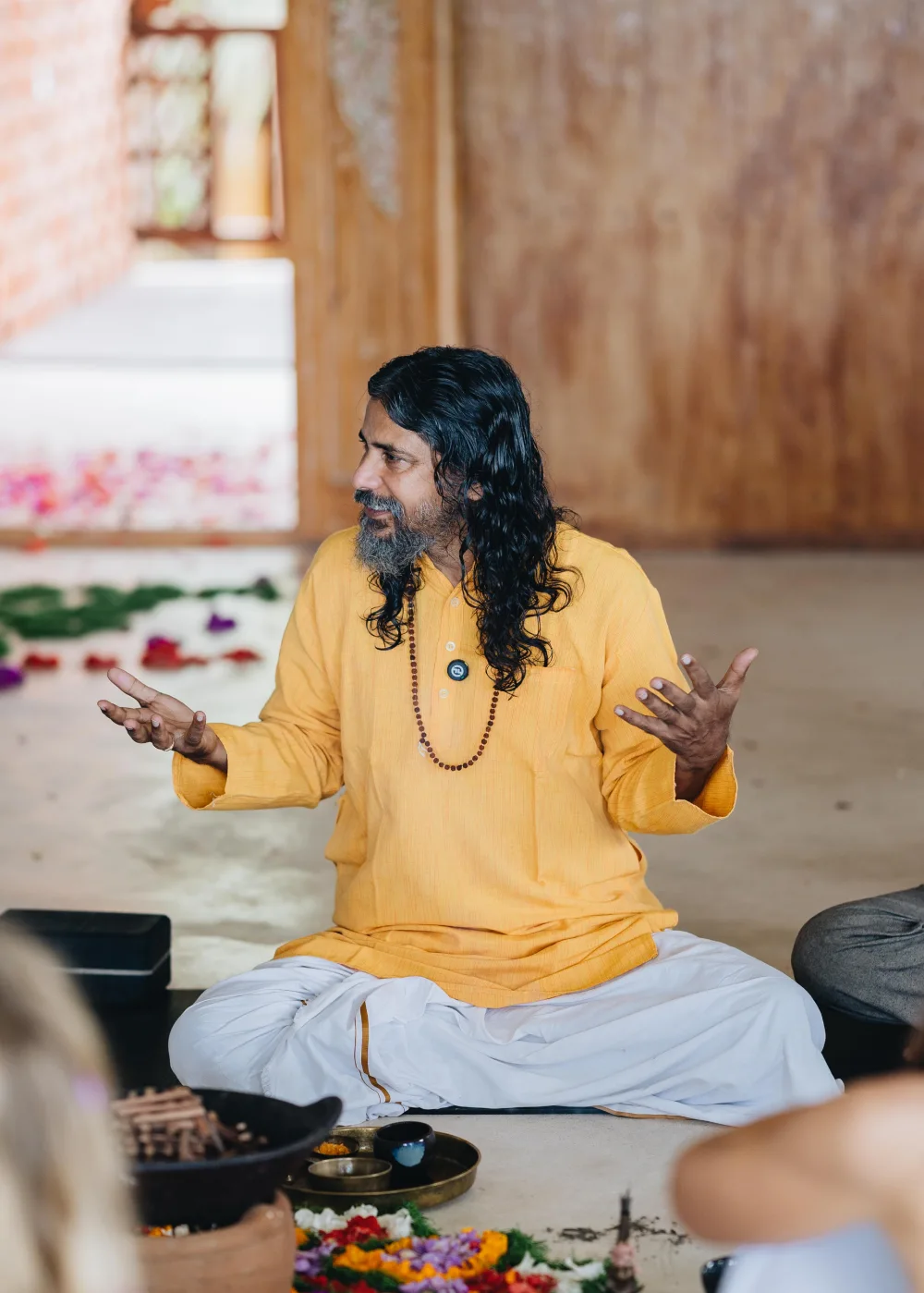 Guru Vishnu teaching seated on the floor of the Bali shala
