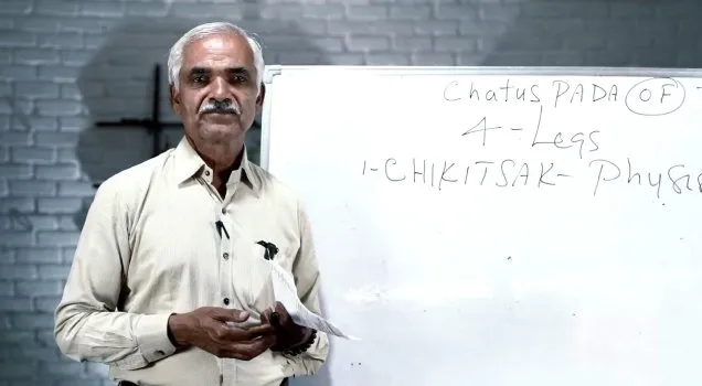 A teacher explaining Ayurveda at a whiteboard