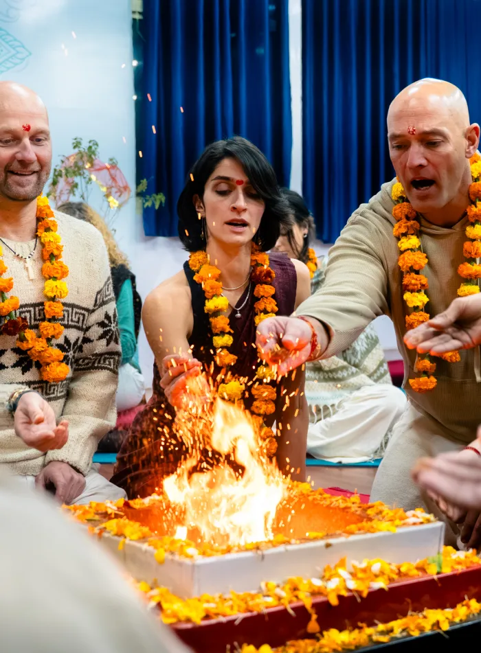 Students offering to the sacred fire during a fire ceremony