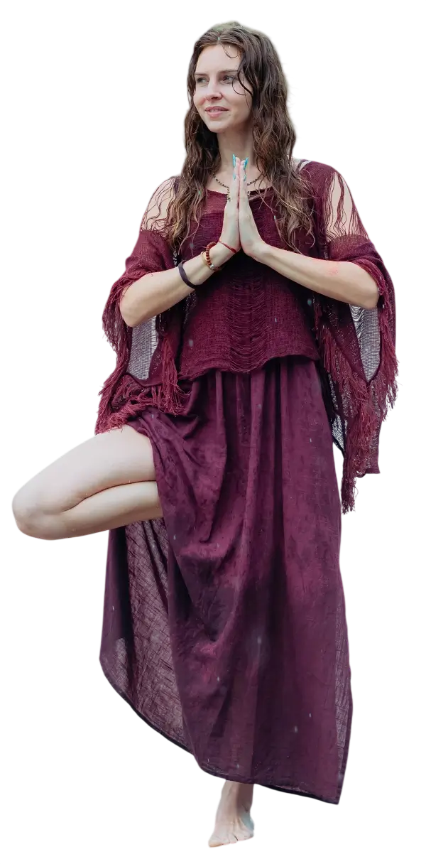 A student standing in tree pose with palms joined