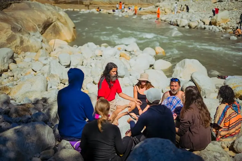 The group in a sharing circle beside the river