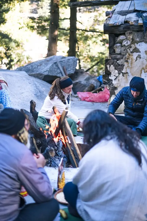 The group gathered around an evening fire at a mountain camp