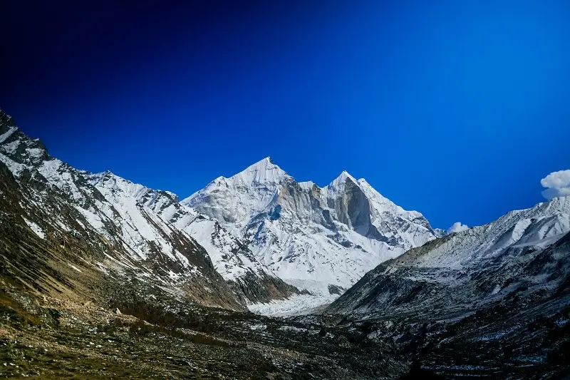 Snow-capped Himalayan peaks under a deep blue sky