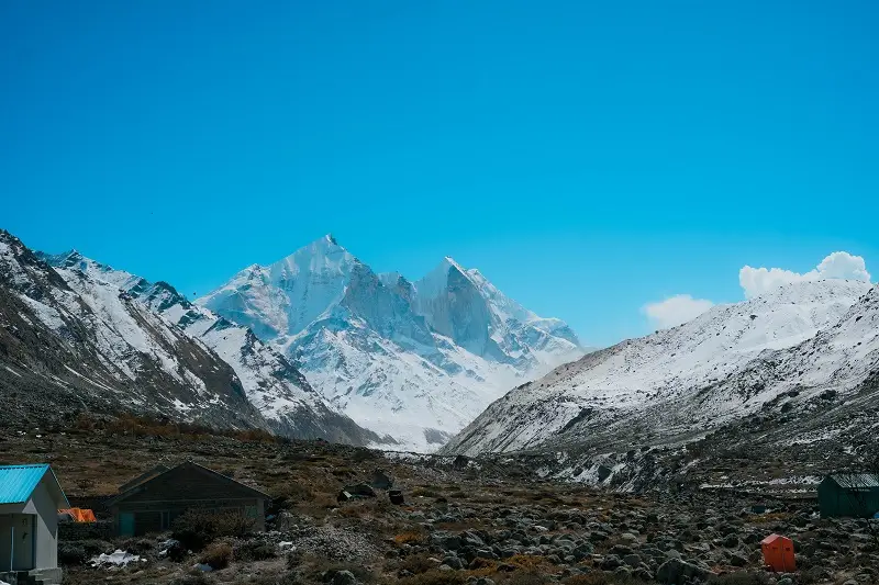 A mountain camp beneath towering snow peaks