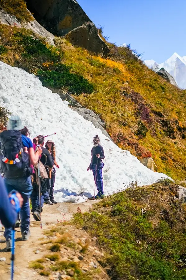 Pilgrims trekking along a snowy Himalayan trail