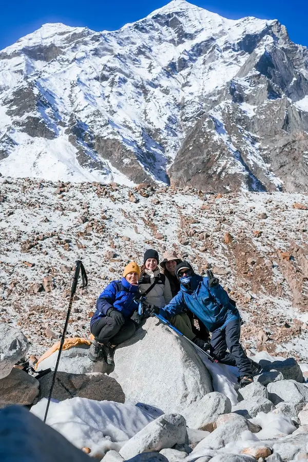 Pilgrims resting together on a snowy mountain slope