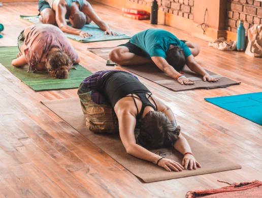 Students resting in child&rsquo;s pose during a Yin Yoga class