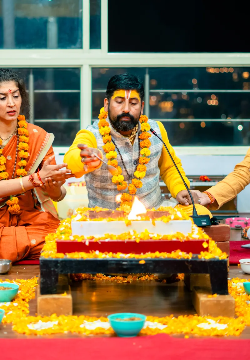 Guru Vishnu offering ghee into the sacred fire during a Mahavidya havan