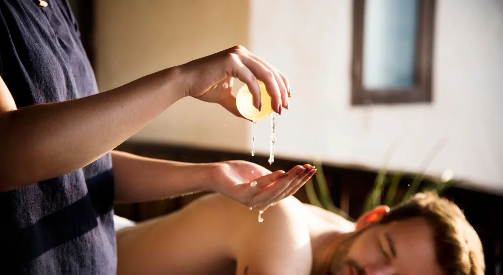 An Abhyangam massage with warm herbal oil at World Peace Wellness
