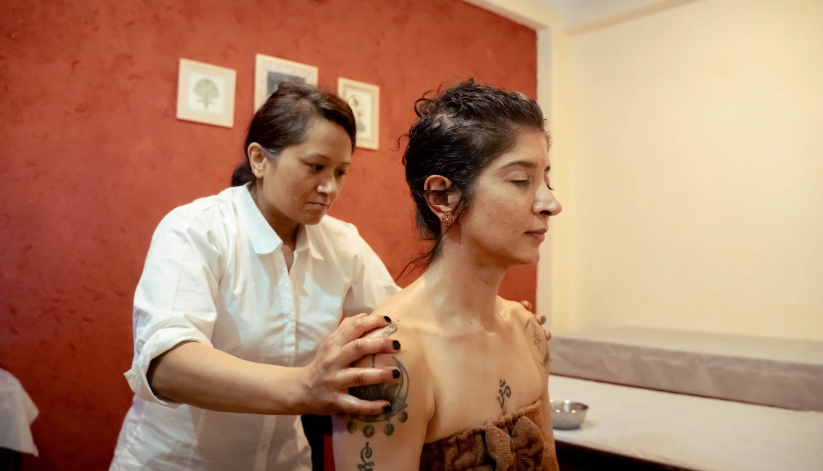 A therapist massaging a guest&rsquo;s shoulders at World Peace Wellness