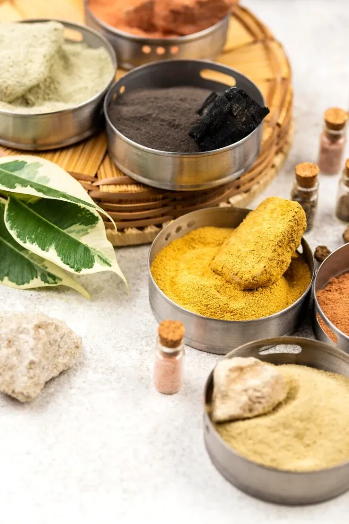 Bowls of Ayurvedic powders and dried herbs