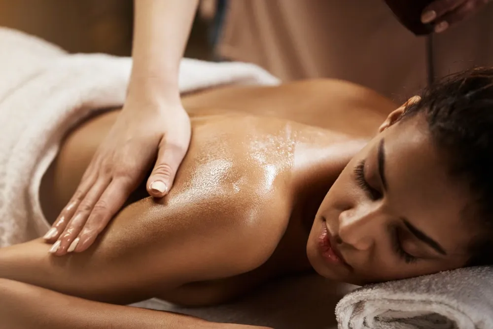 A therapist giving a back oil massage