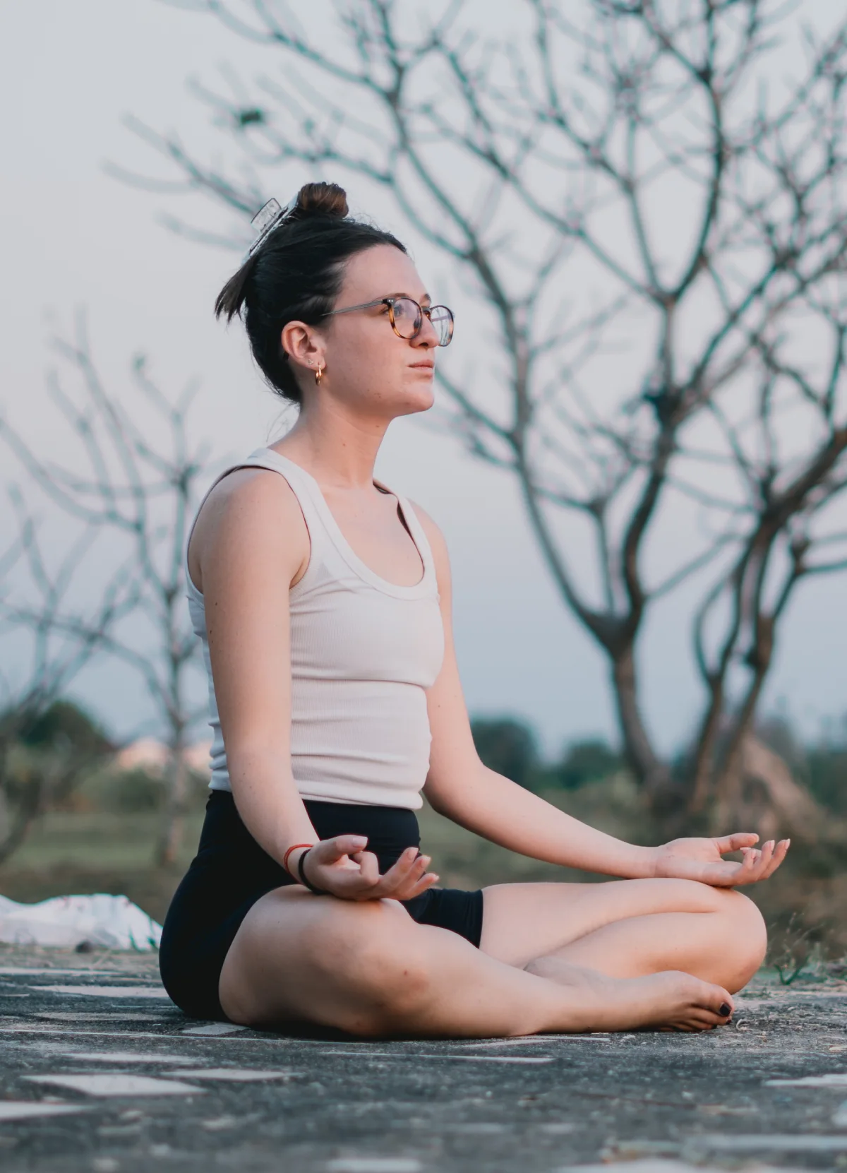 A student meditating outdoors in Gyan mudra