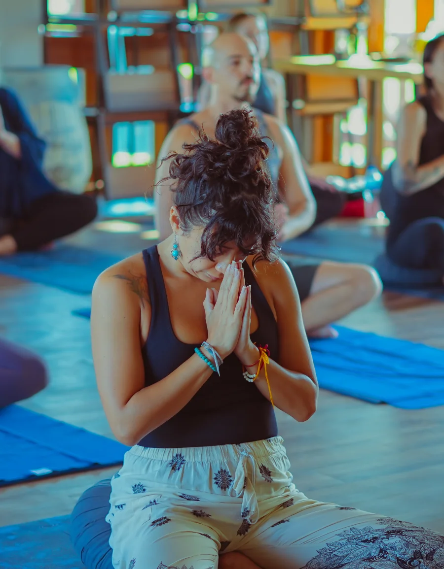 A participant bowing with folded hands during practice