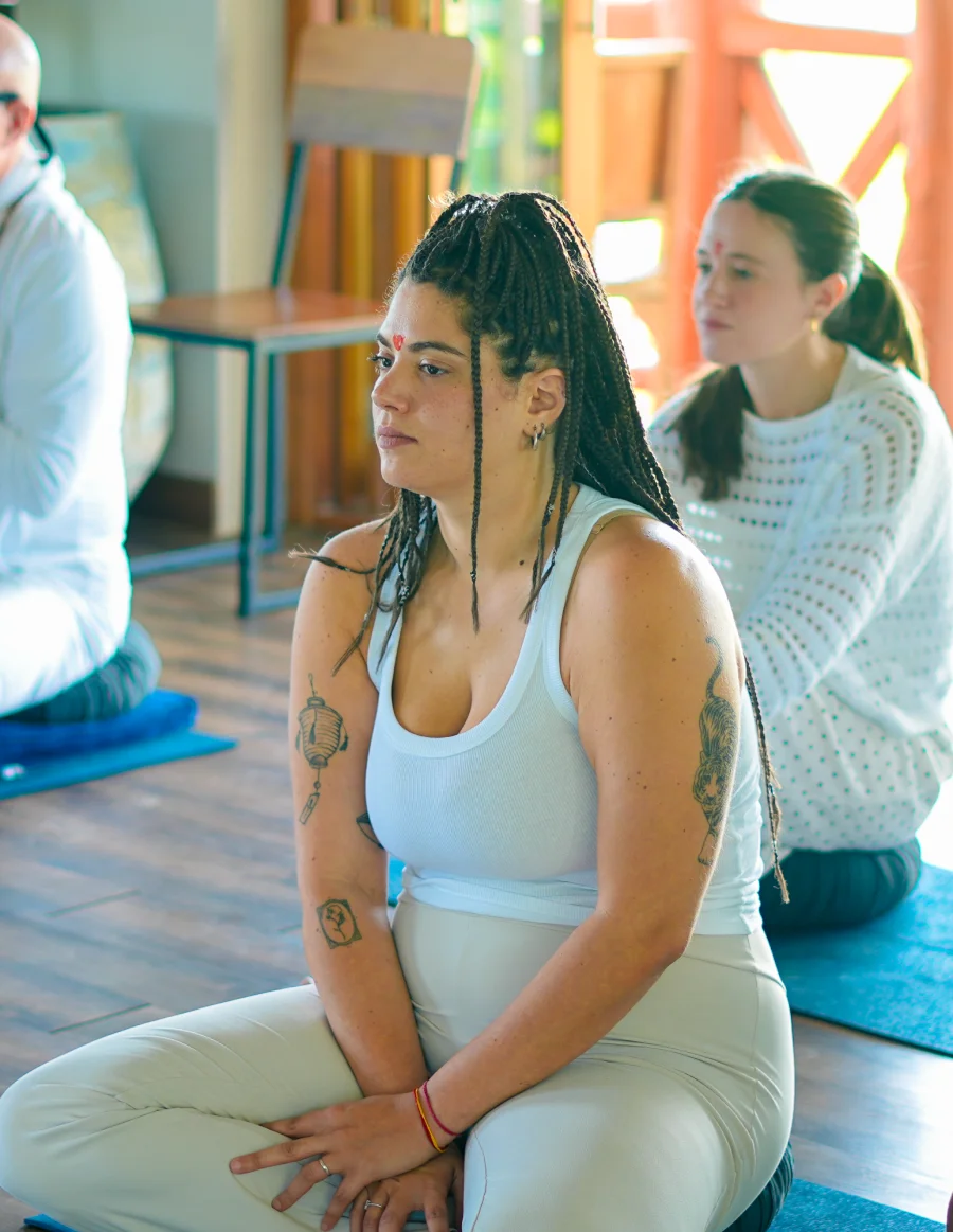 Participants sitting in silent meditation in the hall