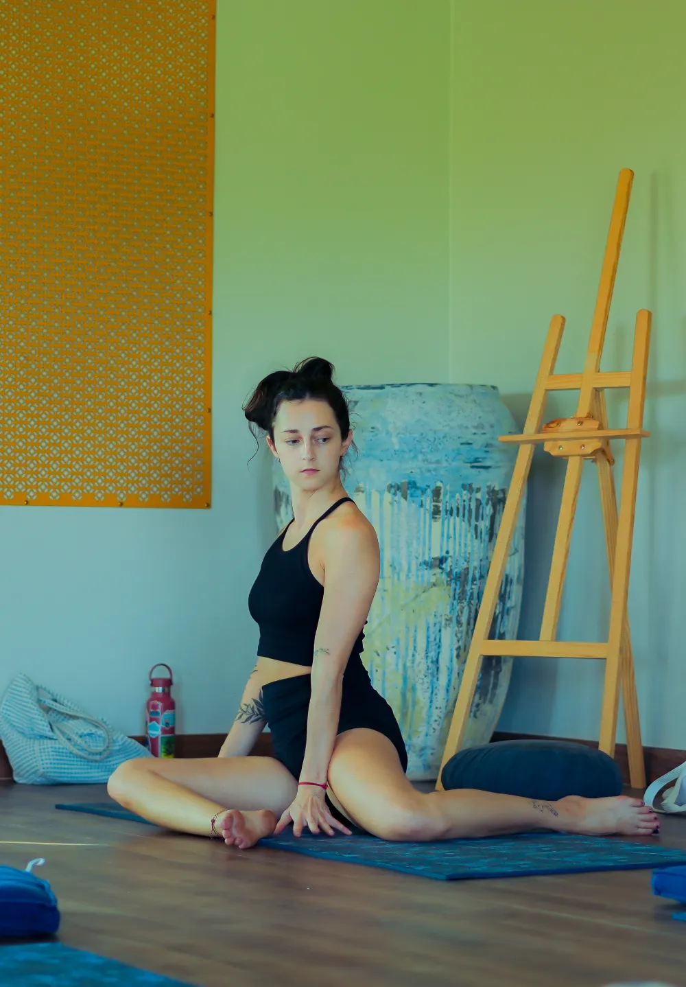 A guest in a seated twist on her mat