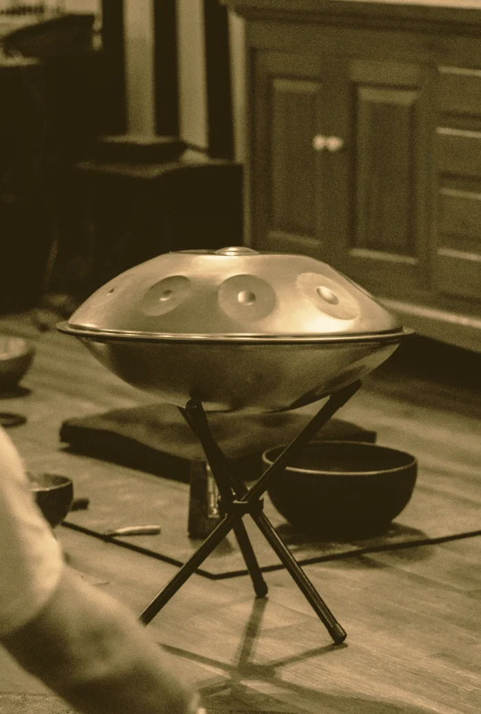 A handpan resting on a stand in the practice hall
