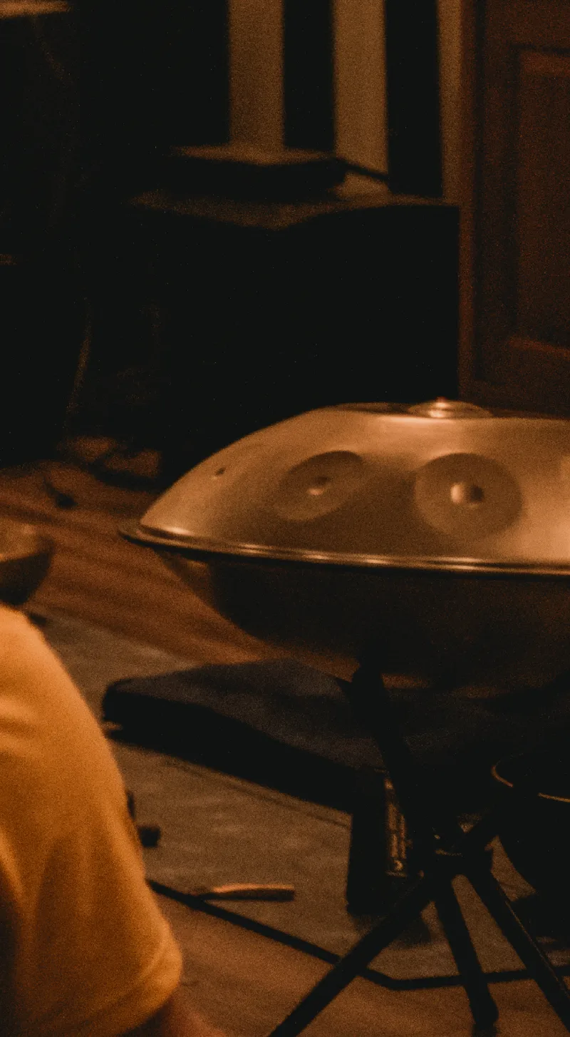 A handpan in warm evening light during a sound session
