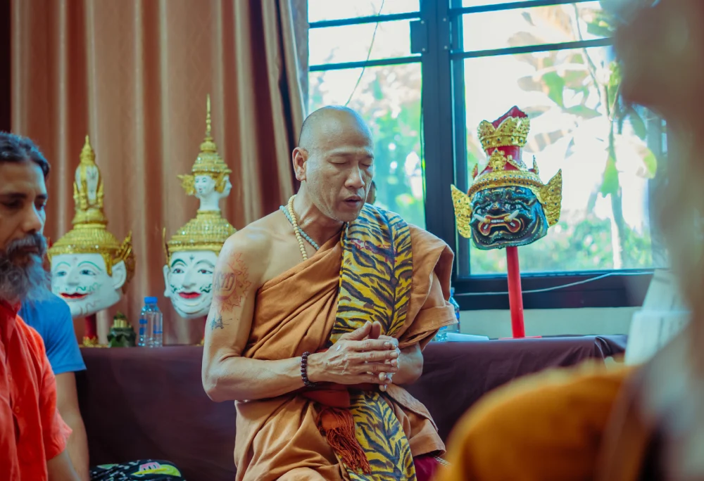 A Thai monk leading a meditation session with students
