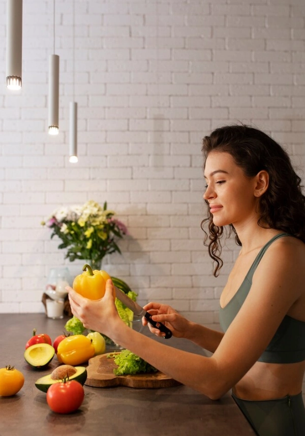 A woman preparing fresh vegetables in a bright kitchen